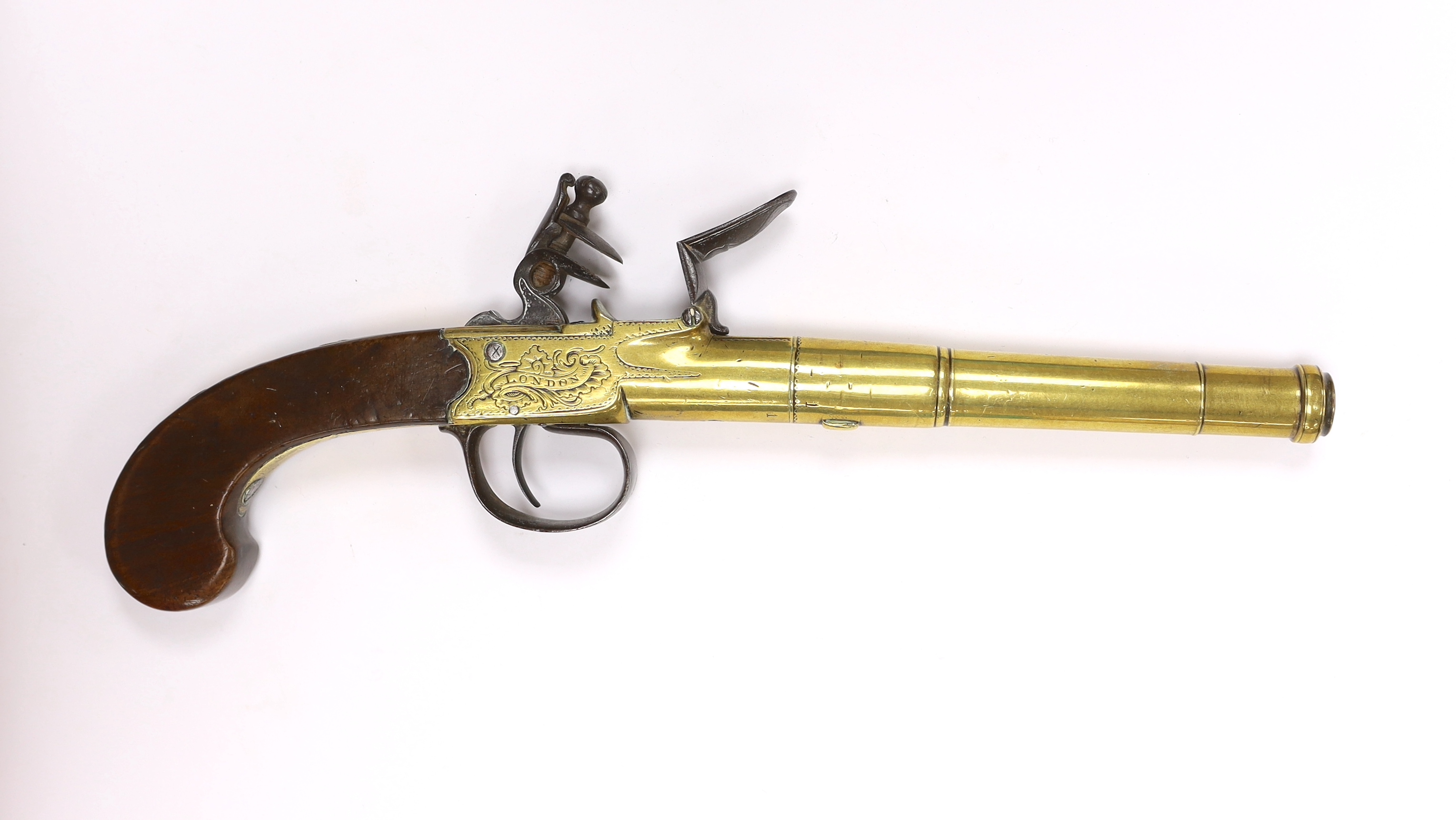 A Queen Anne style, brass cannon barrel boxlock flintlock holster pistol by Hadley of London, with turn-off barrel, private tower proofs, frame signed by the maker, walnut slab grip with unusual silver scion in the form